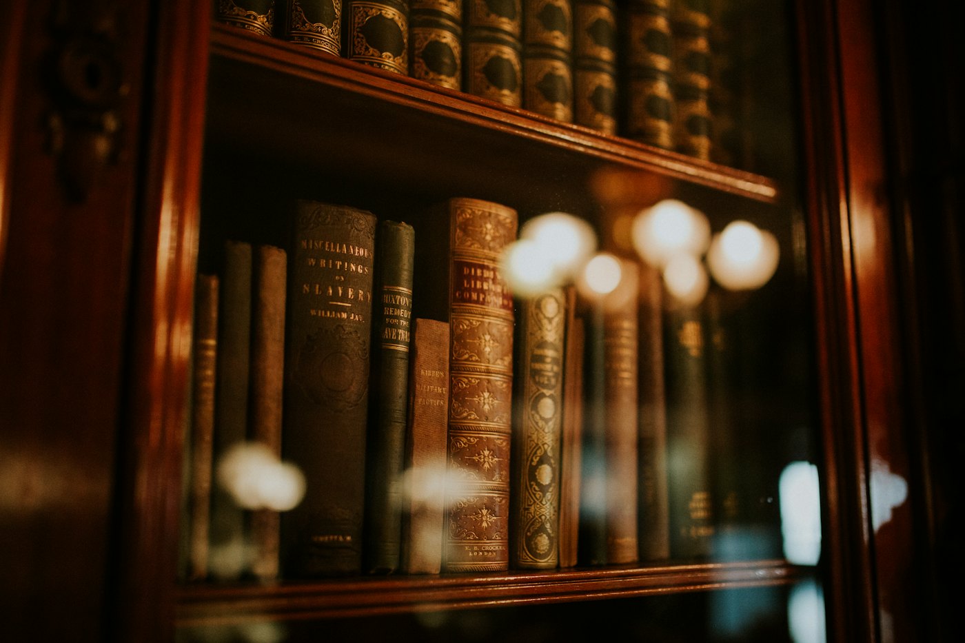 Antique legal volumes behind glass in low light